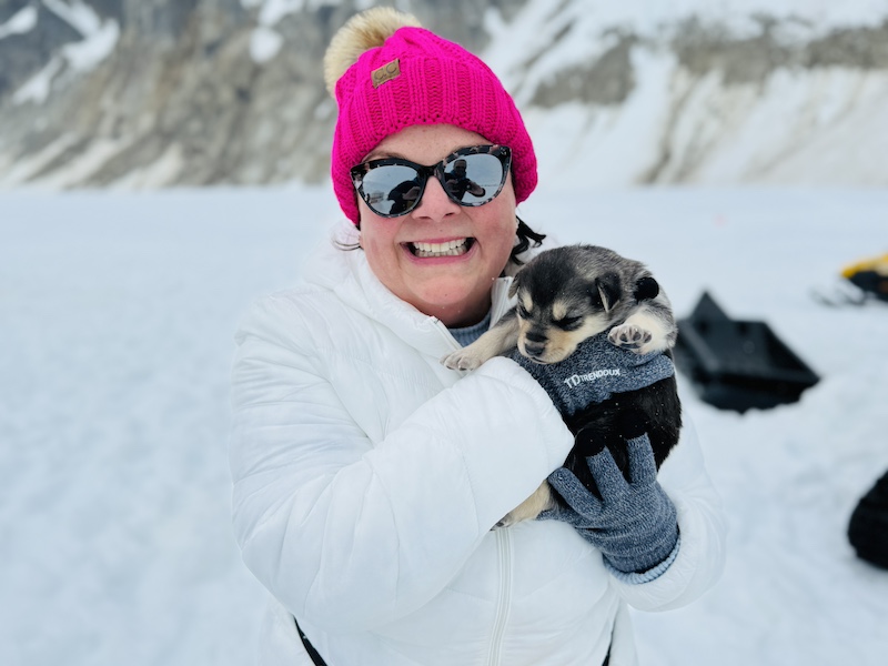 Ann with Alaska Husky puppy on the Denver Glacier near Skagway, Alaska